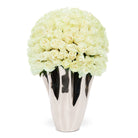 Silver vase with white flowers on a white background