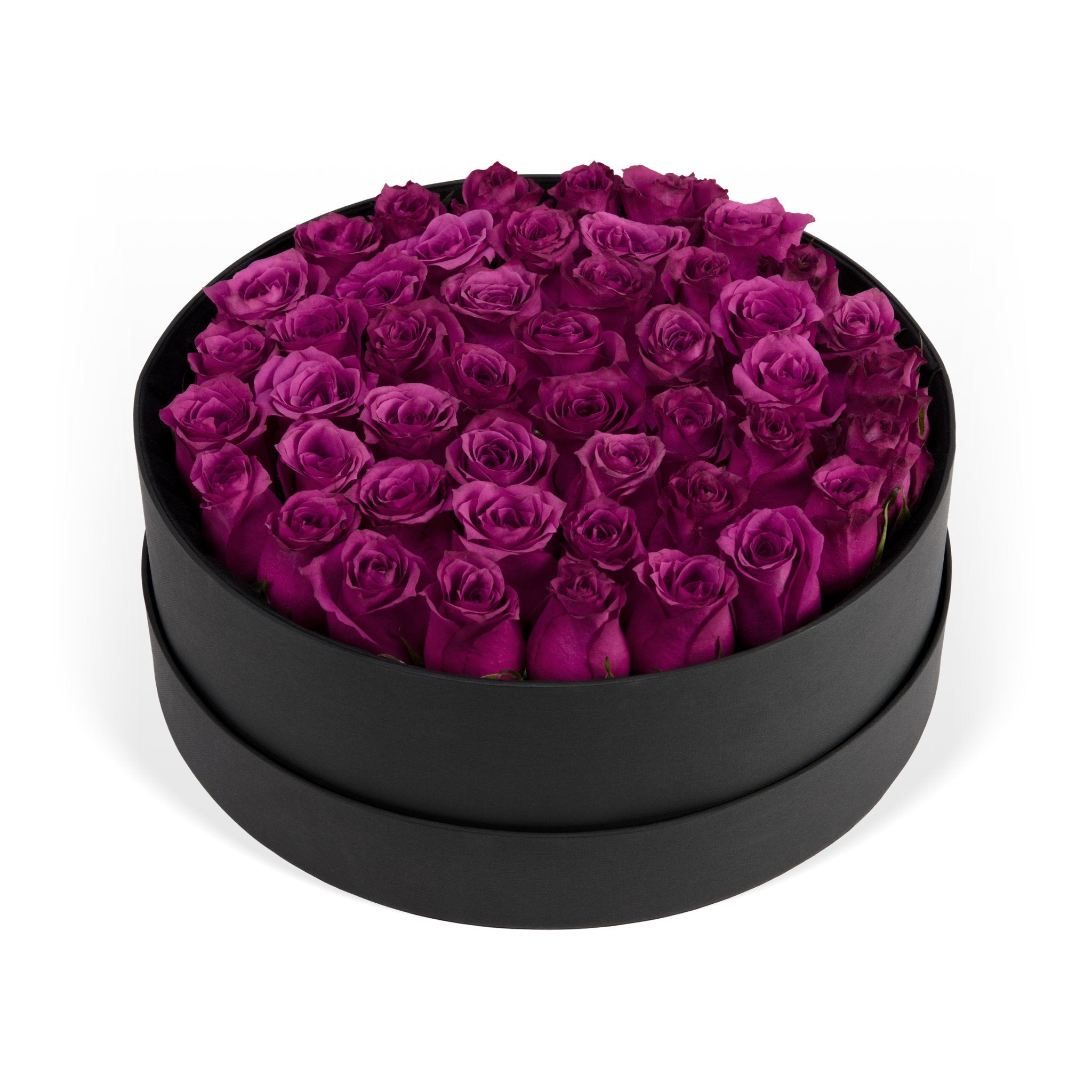 Black round box filled with purple roses on a white background
