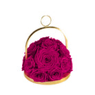 Pink roses in a gold holder on a white background