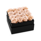 Black box filled with beige roses on a white background