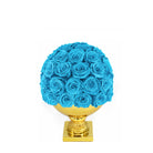 Blue rose ball on a gold pedestal against a white background