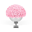 Pink roses in a silver vase on a white background