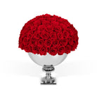 Bouquet of red roses in a silver vase on a white background