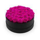 Black box filled with pink roses on a white background