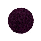 Round arrangement of dark purple roses on a white background