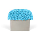 Decorative box with blue rose arrangement on a white background