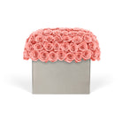 Decorative box with coral pink roses on a white background
